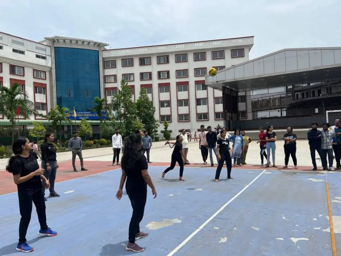 Students playing volleyball on campus court